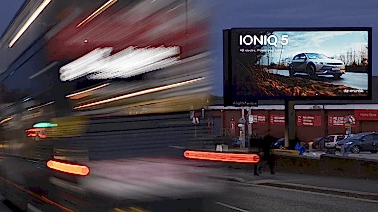 Hyundai IONIQ 5 advertisement with red bus
