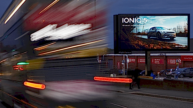 Hyundai IONIQ 5 advertisement with red bus