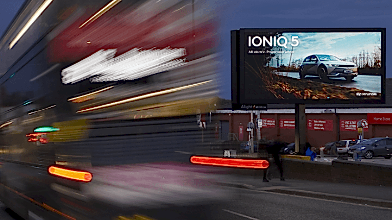 Hyundai IONIQ 5 advertisement with red bus