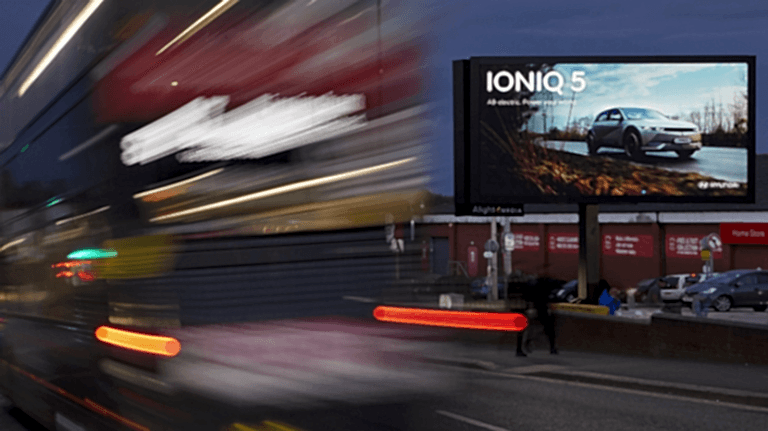 Hyundai IONIQ 5 advertisement with red bus