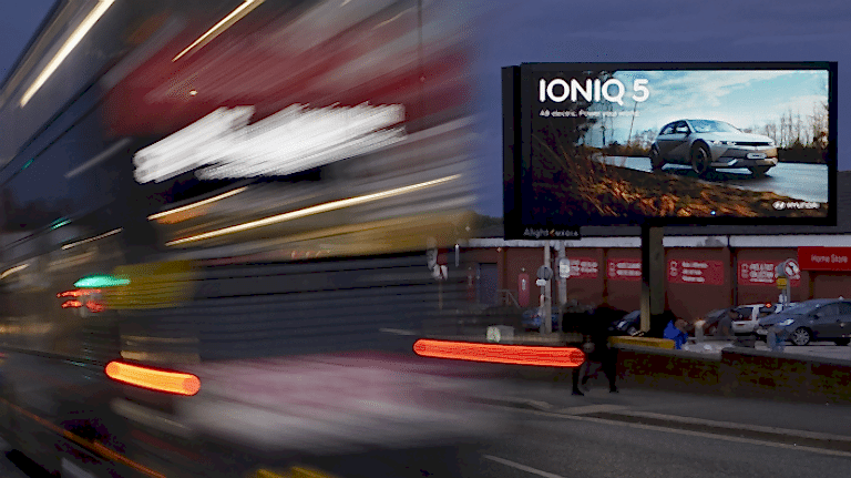 Hyundai IONIQ 5 advertisement with red bus