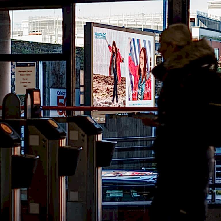 Regatta Outdoor billboard viewed through train station window